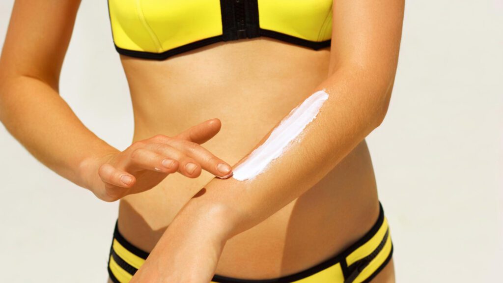 Woman applying fake tan