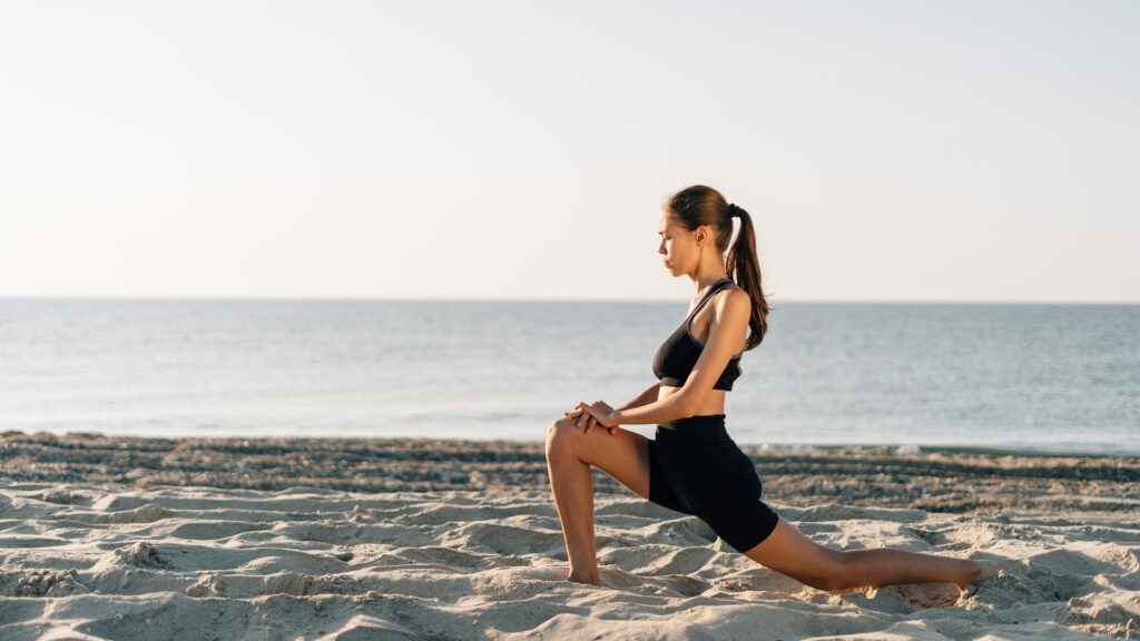 woman exercising at beach to burn calories