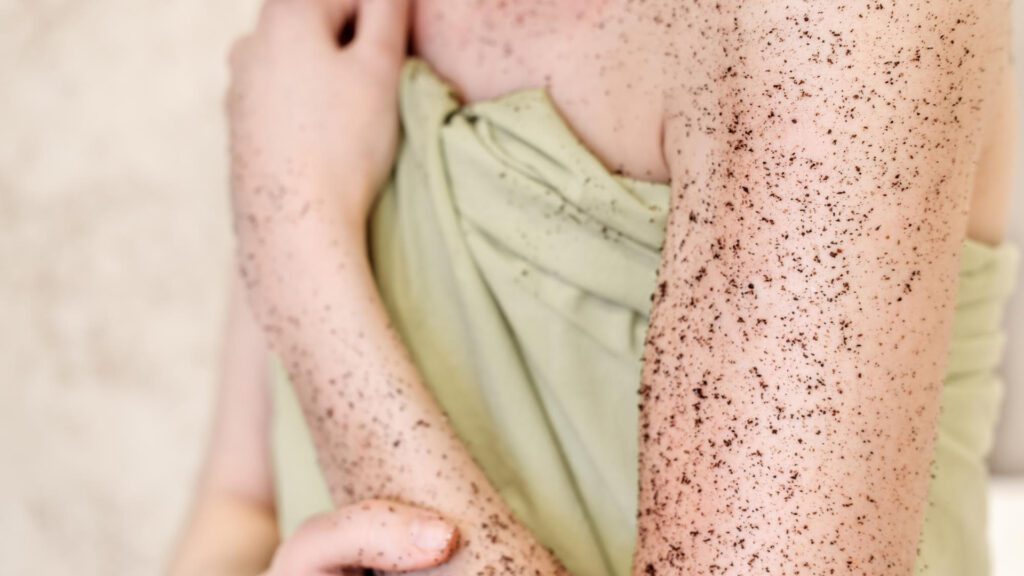 Woman exfoliating before tanning to make self tanner last longer
