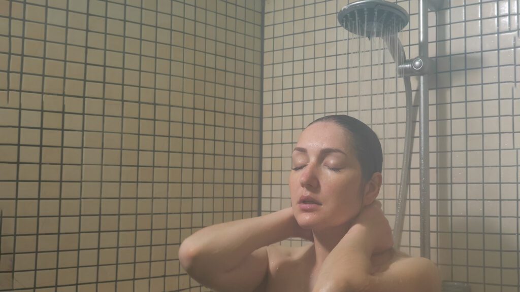 Woman taking a shower after sleeping in self tanner