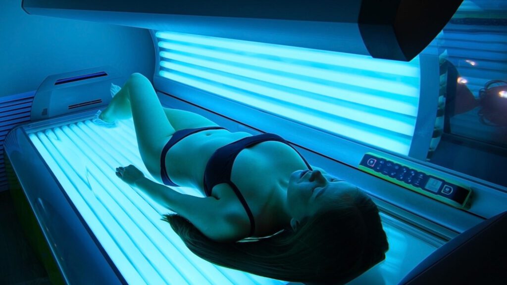 Woman lying in Tanning bed to cure seasonal depression