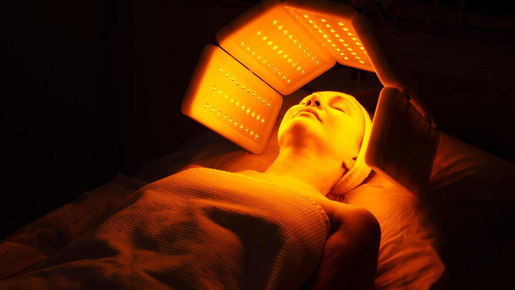 woman having red light therapy after tanning